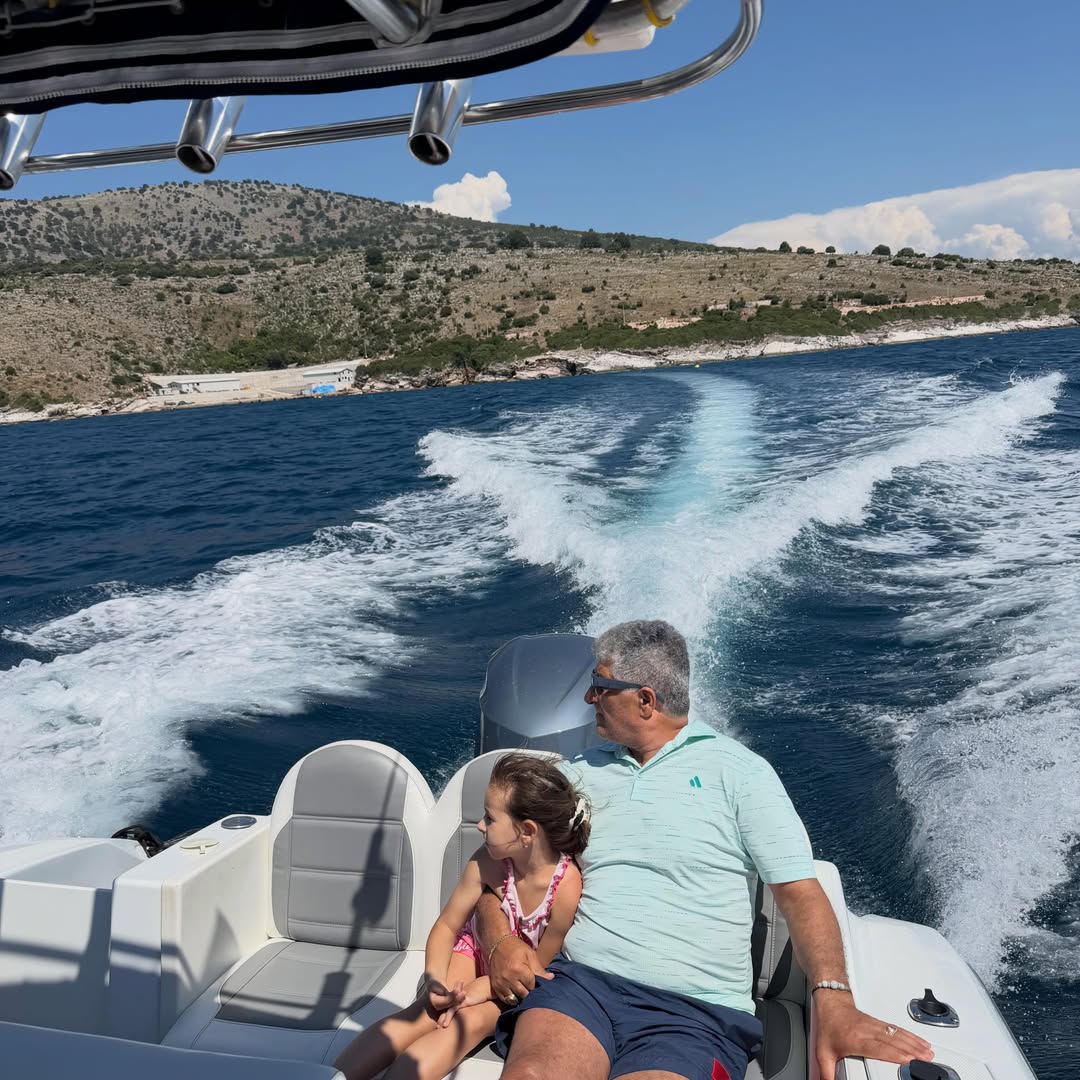Aerial view of the Gloria Boat speeding through deep blue Albanian Riviera water